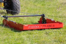 paddock blade pro in a field with a quad bike
