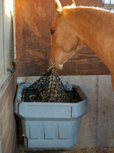 horse eating from a hay feeder hay optimizer