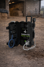 Paddock Pulse Pro device on a dirt floor with a barn interior in the background